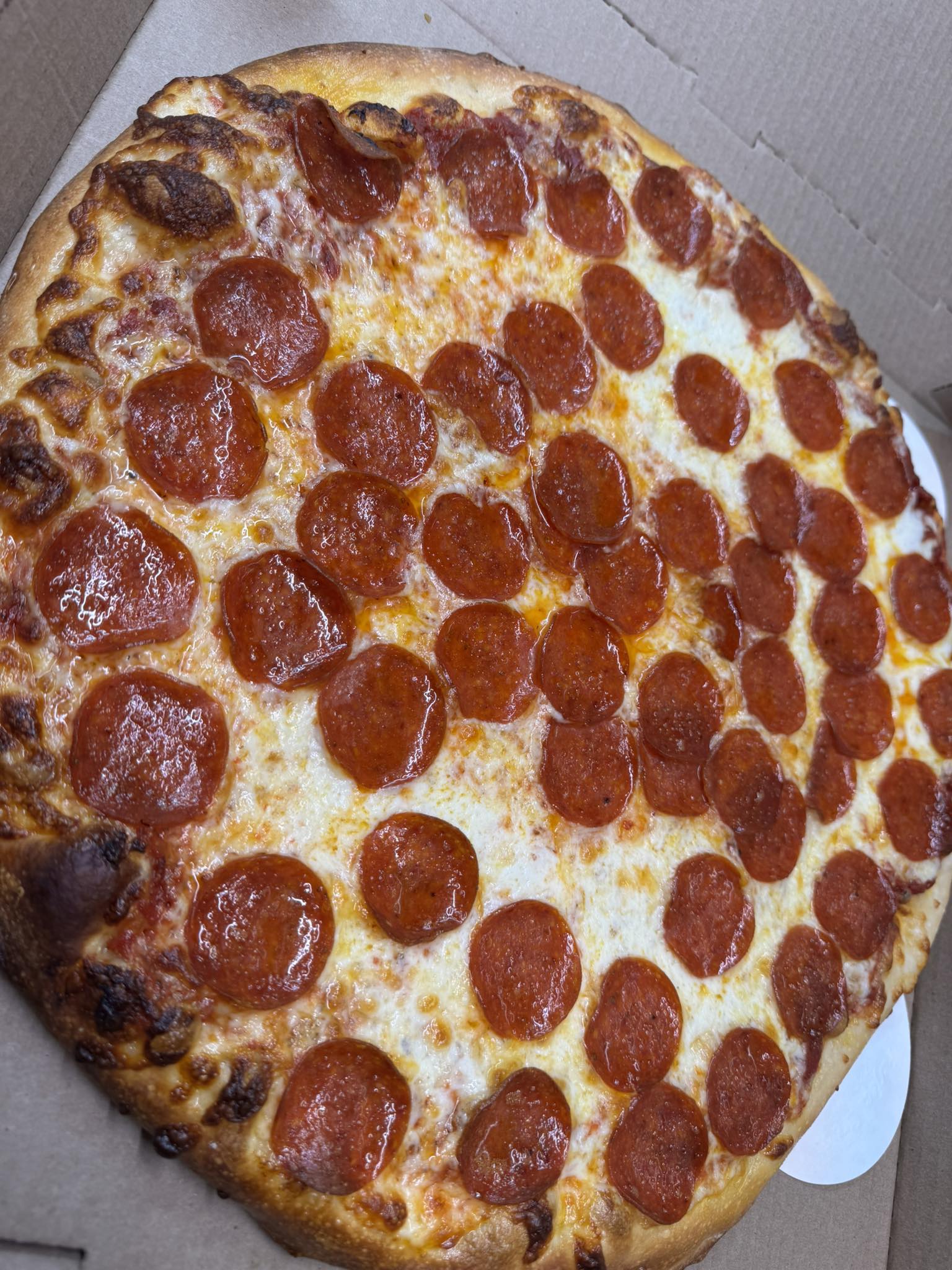 Whole pepperoni pizza fresh from Eddie's oven
