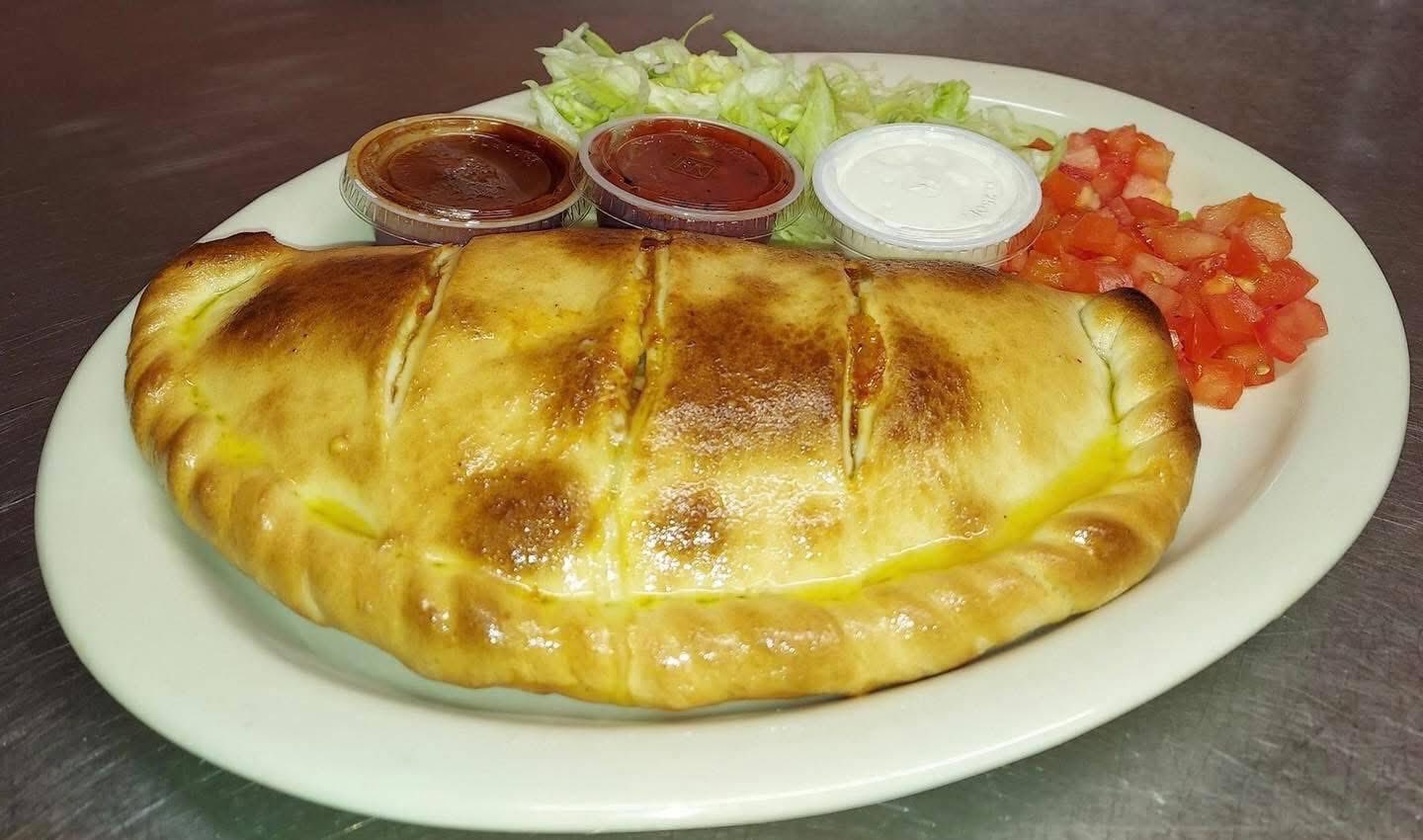 Golden baked calzone with dipping sauces
