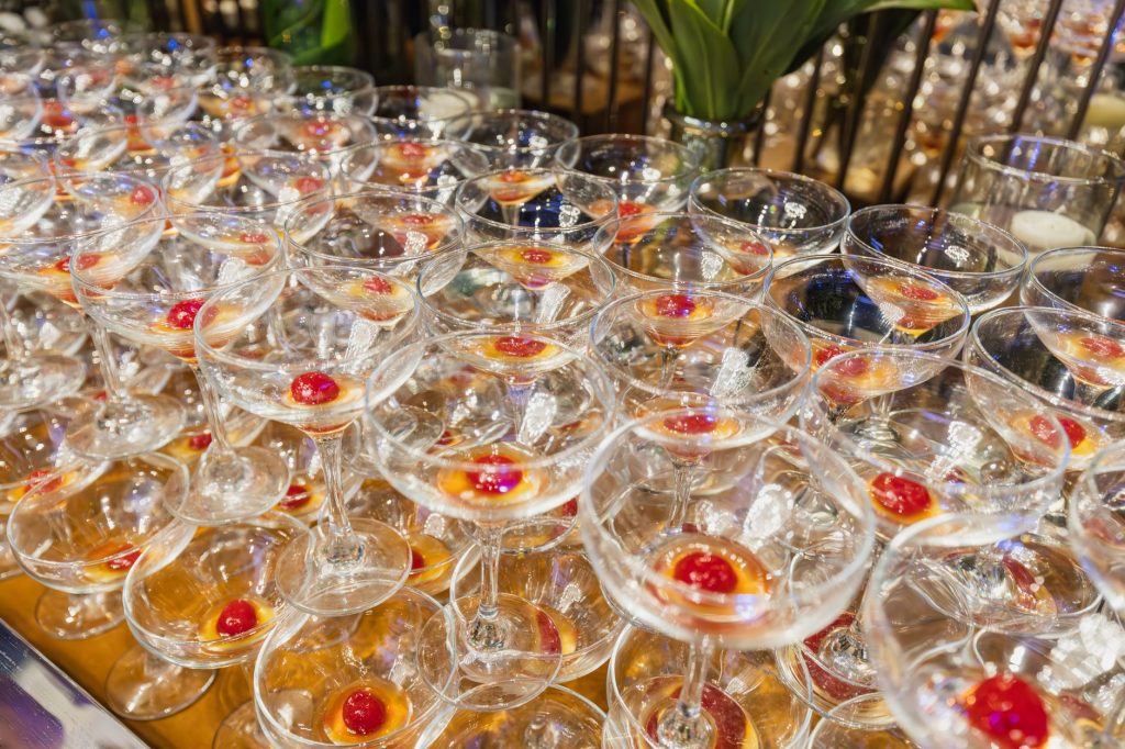 Close-up of elegant cocktail glasses with red cherries, ideal for party scenes.
