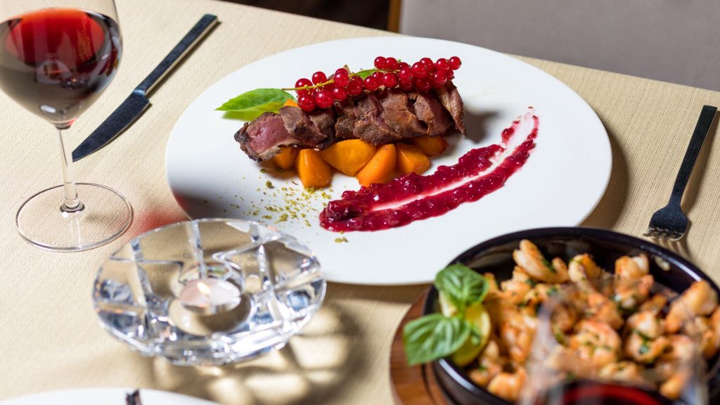Delicious gourmet steak dinner with wine, served elegantly for fine dining.