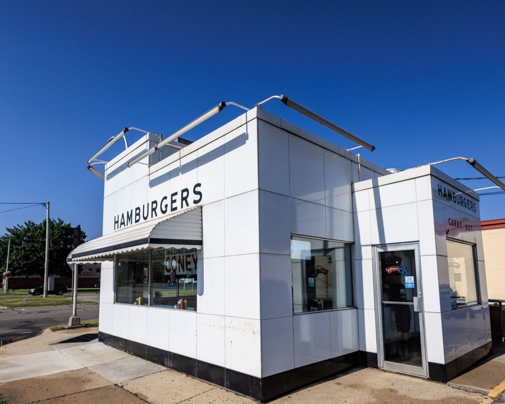 Exterior of a classic American diner with a vintage design in Livonia, Michigan. Clear blue sky emphasizes the nostalgic a…