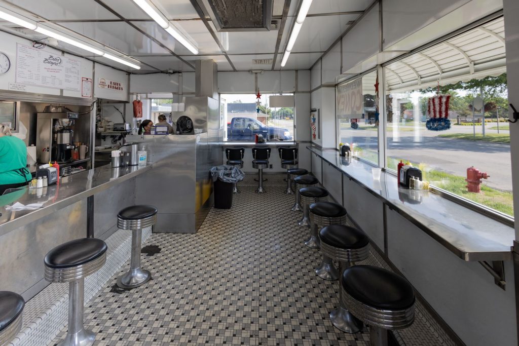 Retro diner interior with checkered floor and stool seating in Livonia, Michigan.