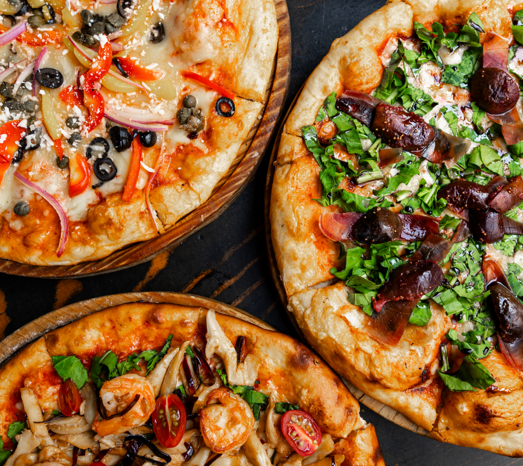 Tantalizing selection of gourmet pizzas with fresh toppings in Mexico City's vibrant dining scene.