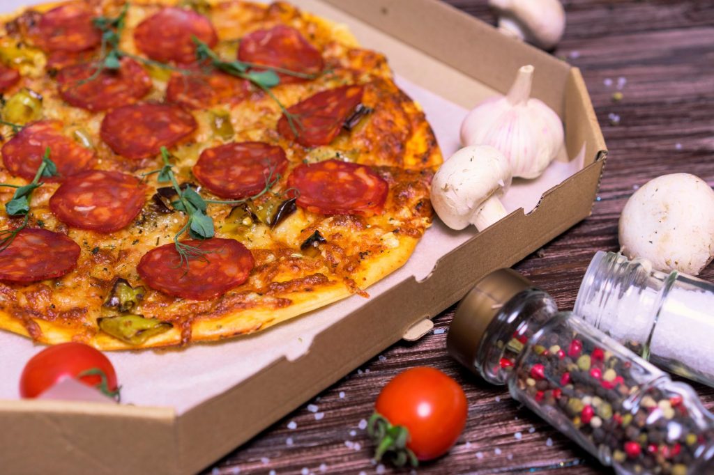Tasty pepperoni pizza with mushrooms and tomatoes, perfect for a flavorful meal.